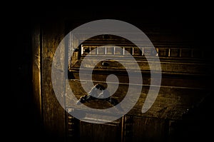 Close up view of old antique wooden door inside dark room. Selective focus