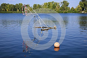 Close-up view of old canoe polo gate on the river. Ball gate on the pond for canoe polo. Sunny autumn day