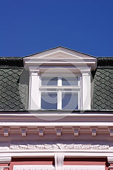 Close up view of old dormer window on the roof