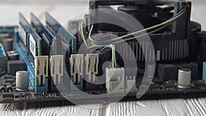 Close up view of an old dusty motherboard. The depth of field is short and has some rack focusing. The lighting is high