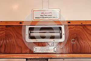 Close-up view of an old emergency alarm pull system, located in a first class passenger train car.