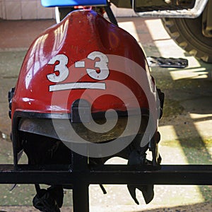 Close-up view of old red fire helmet. 911 concept