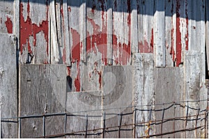 Close up view of old weathered red siding on a 19th Century wooden barn