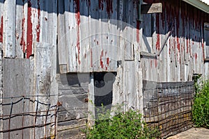 Close up view of old weathered red siding on a 19th Century wooden barn