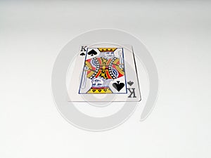 A close up view at one king card with a spade suit from a deck of playing cards. The concept of games, gambling, fun and free time