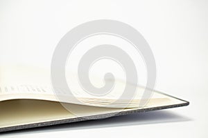 Close-up view of opened calendar diary pages with dates on white background with free space and selective focus