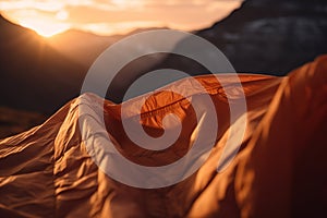 close-up view of Orange sleeping bag in mountains on background. Generative ai