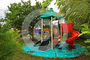 Close up view of outdoor children playground activity place on local Maldive island Danghethi. Green trees on background