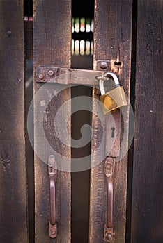 Close up view of a padlock and old wooden door