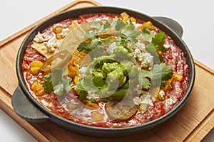 Close-up view pan with Shakshuka dish with spicy sauce from tomatoes.