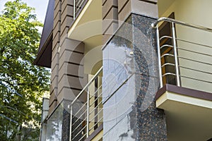 Close up view of part of a building facade with the surface of granite wall. Natural stone materials
