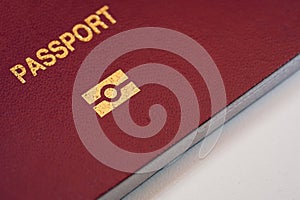 A close up view of Passport text and e-passport signin a red Passport cover