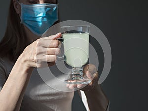 Close-up view photo of female hands holding glass of water. Young woman taking medication, feeling ill.