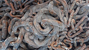 close up view of pile of old, dirty and rusty big and smaller windlass chains