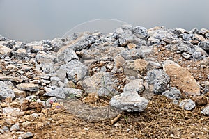 Close-up view: Piles of broken concrete debris taken from road demolition are left on a mound