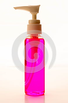 Close-up view of pink hand sanitizer isolated on white background