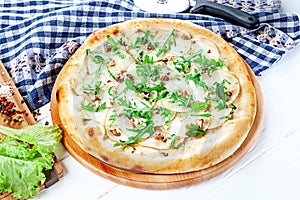 Close up view on pizza on white wooden background with ingridients. Italian cuisine.