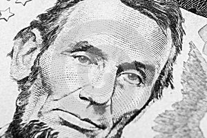 Close up view Portrait of Abraham Lincoln on the one five dollar bill. Background of the money. 5 dollar bill with Abraham Lincoln