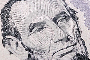 Close up view Portrait of Abraham Lincoln on the one five dollar bill. Background of the money. 5 dollar bill with Abraham Lincoln