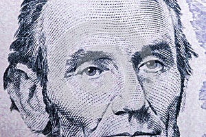 Close up view Portrait of Abraham Lincoln on the one five dollar bill. Background of the money. 5 dollar bill with Abraham Lincoln