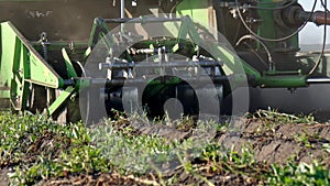 close up view of potato harvester at work. equipment move along beds and take potatoe upstair for sorting and shipment