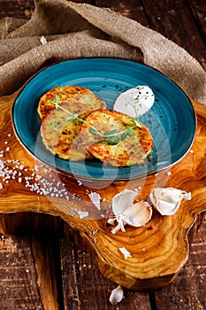 Close-up view of potato pancakes. Potato cake on a blue plate on a wooden table