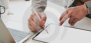 Close-up view of professional businessman writing his idea on blank screen laptop computer