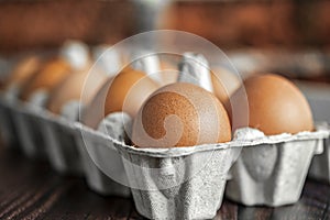 Close-up view of raw chicken eggs on wooden background. Fresh farm egg.