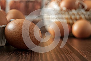 Close-up view of raw chicken eggs on wooden background. Fresh farm egg. eggs in carton box.