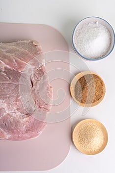 Close-up view of raw meat and meat seasonings.