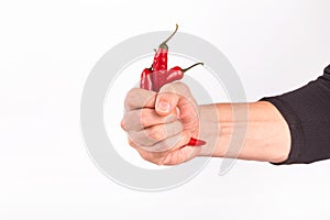 Close-up view of red chili pepper in the hands of a male cook, selective focus