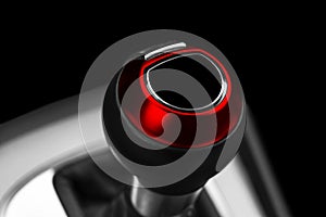 Close up view of a red gear lever shift. Manual gearbox. Car interior details. Car transmission. Soft lighting. Abstract view. Car