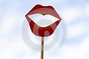 close up view of a red paper lips photo booth props