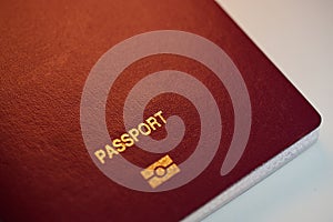 A close up view of a red Passport cover with e-passport sign in White Background