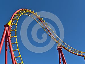 Close-up view of the red and yellow colored rails of a roller coaster in park Wurstelprater in Vienna, Austria.