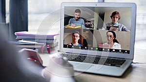 Close up view of remote employee conferencing in online group virtual chat on laptop screen. Company staff colleagues