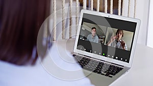 Close up view of remote employee conferencing in online group virtual chat on laptop screen. Company staff colleagues