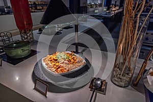 Close-up view of restaurant interior with hot fried shrimp on plates for buffet.