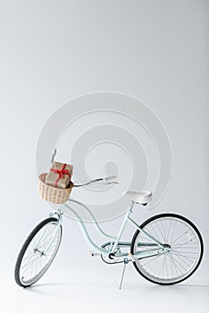 close up view of retro bicycle with wrapped christmas gift in basket