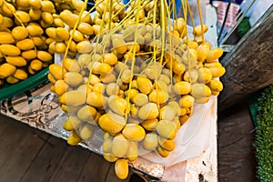 A close-up view of a ripe bunch of yellow dates