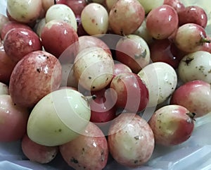 Close-up view of ripe colorful carissa carandas fruit