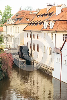 Close-up view of the river port near surrounded by old buildings and colourful trees. Prague location.