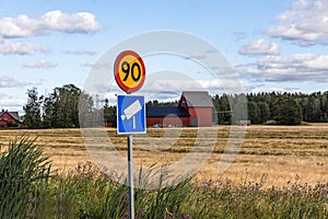 Close up view of road signs on yellow field and blue sky with white couds backgrounds.