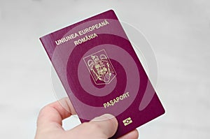 Close up view of a Romanian passport on a white background . Documents required to travel to countries around the world