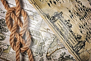 Close-up view of a rope sea knot on an old retro map