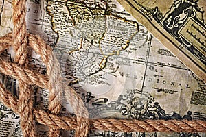 Close-up view of a rope sea knot on an old retro map