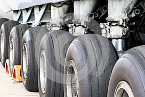 Close up view of a row of tires on the main landing gear of a large transport plane