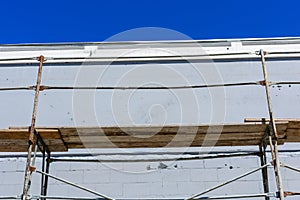 Close up view of rusty metal scaffolding with working wooden platform