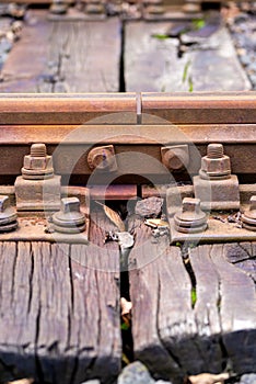 Close-Up View of Rusty Railway Track and Wooden Sleepers