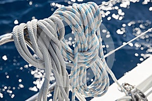 Close-up view of sailboat ropes at sunny weather, pulleys and ropes on the mast, Yachting sport, ship equipment, sea is